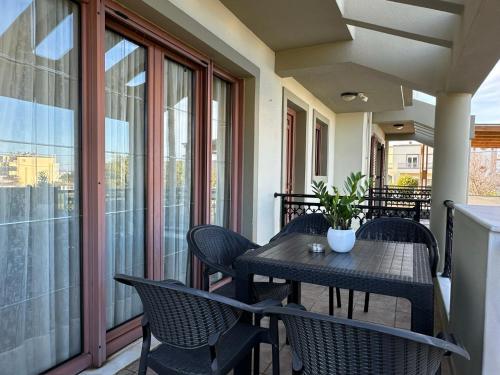 a porch with a table and chairs on a balcony at Eleni's Luxury Stay - Kos in Zipárion