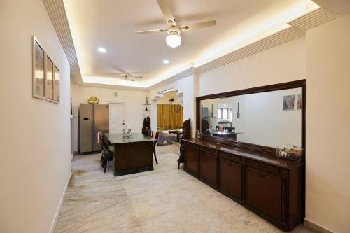 a living room with a table and a large mirror at RoofTop-1BHK for Families only @HimayathNagar in Hyderabad