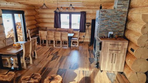 a dining room in a log cabin with a table and chairs at Zrub Poľana - Liptovská Mara in Ižipovce