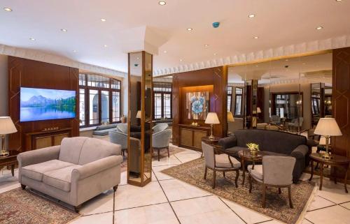 a living room with couches and a tv in it at Vardar Palace Hotel - Special Category in Istanbul