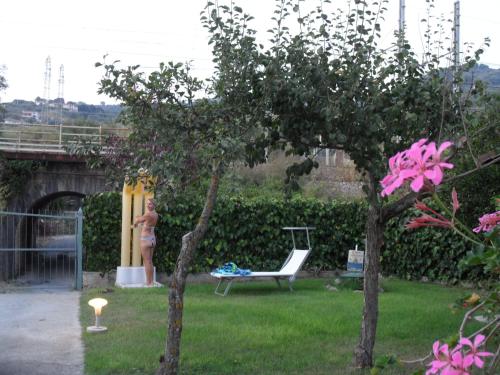 a woman in a bikini standing in a yard at Villa Comics in Villammare