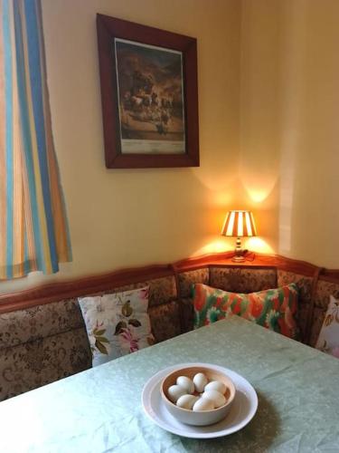 a table with a bowl of eggs on top of it at Studniska Country Estate in Studniska