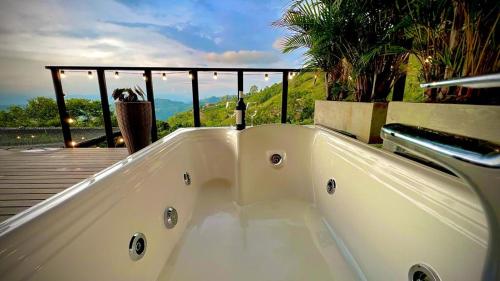 a white bath tub sitting on top of a deck at Ecovillage glamping Idilio in Llanitos