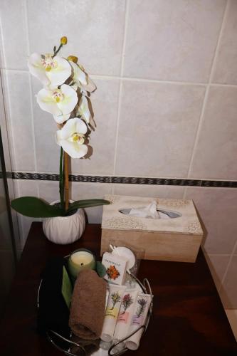 a vase of white flowers sitting on a table at The Leopard Tree in Polokwane