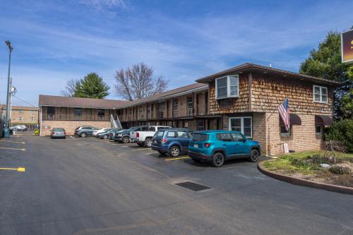 a parking lot with cars parked in front of a building at Sunrise Inn Hershey in Hershey