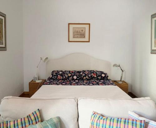 a bedroom with a large bed with a couch at Your place in San Frediano in Florence