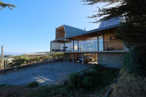 a house on the side of a hill with a driveway at Casa Mirador Roca in Matanzas