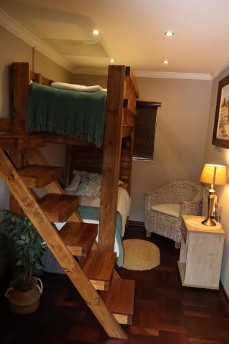 a room with two bunk beds and a table at The Leopard Tree in Polokwane