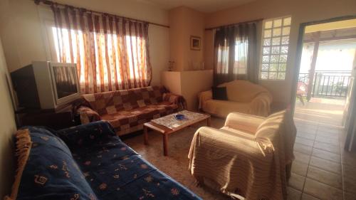 a living room with a couch and a table at Polis Houses in Nea Iraklia