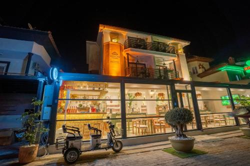 a building with two scooters parked in front of it at Jasmine Marmaris in Marmaris