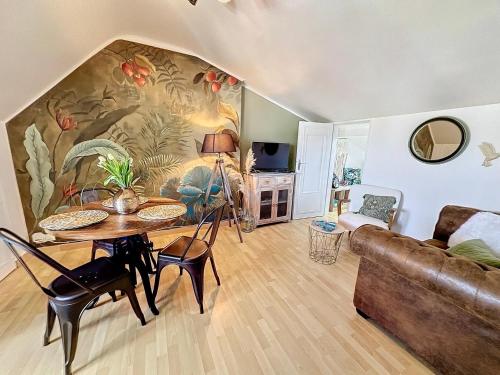 a living room with a table and a couch at Escale en bord de mer T3 au coeur de Saint-Quay in Saint-Quay-Portrieux