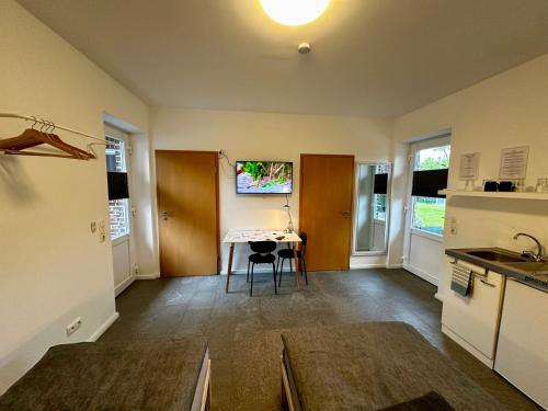 a kitchen with a table and a desk in it at Ferienapartment am Glück in Bad Zwischenahn