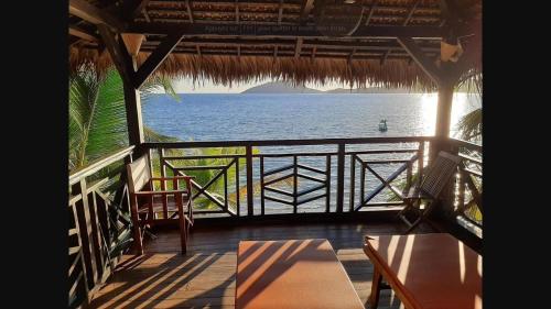 a view of the ocean from a resort balcony at Ô Bleu Azur in Antsatrakolo