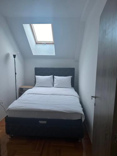 a bed in a small room with a window at Port 4 in Belgrade