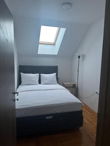 a bedroom with a bed with a window in it at Port 4 in Belgrade
