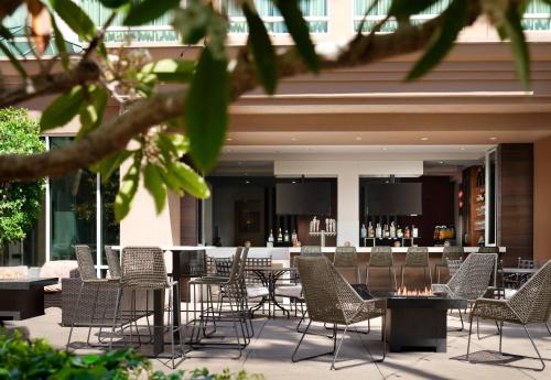 a patio with chairs and a bar in a building at DoubleTree by Hilton San Diego Del Mar in San Diego