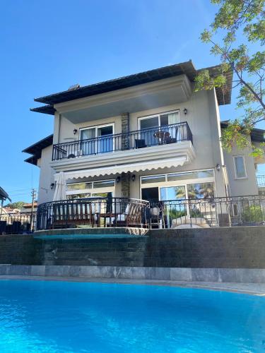 a house with a swimming pool in front of a house at Villa Sophia Marmaris in Marmaris