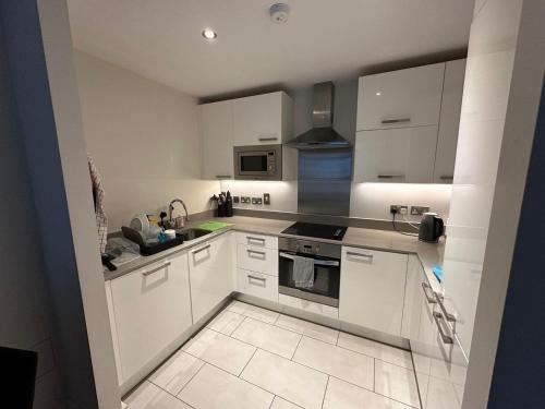 a white kitchen with white cabinets and appliances at Double Room Homestay in Dublin