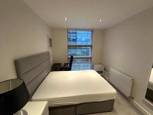 a bedroom with a white bed and a window at Double Room Homestay in Dublin