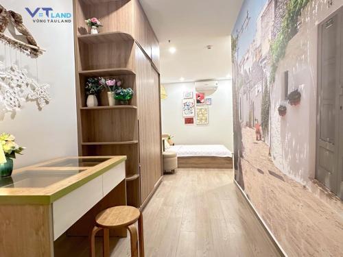 a corridor of a room with a desk and a toilet at The Sóng Hotel & Apartment Vũng Tàu in Vung Tau