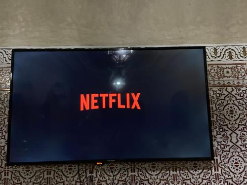 a television screen with the netflix sign on it at Riad malak in Marrakesh