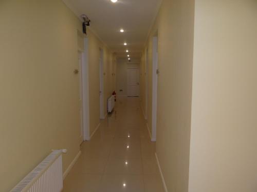 a long hallway with white walls and white floors at Hotel Del Rio in Constitución
