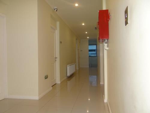 a hallway with a red phone on a wall at Hotel Del Rio in Constitución