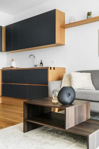a living room with a coffee table and a couch at Above the clouds on 42nd floor in Aarhus