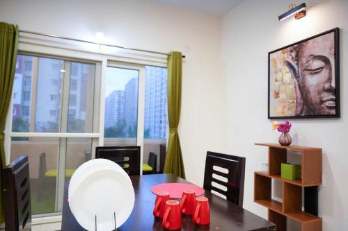 a dining room with a table and a large window at Casa Feliz @ Near US Embassy , Gachibowli in Hyderabad