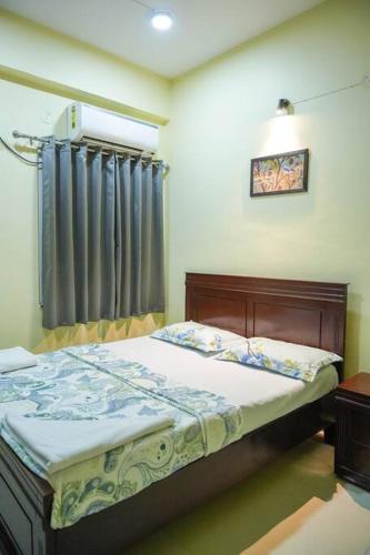 a bedroom with a bed and a window with curtains at Casa Feliz @ Near US Embassy , Gachibowli in Hyderabad