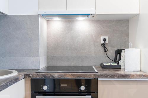a kitchen with a sink and a counter top at Apartments Royal - Sakura Park in Novi Beograd