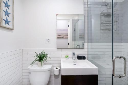 a white bathroom with a toilet and a sink at 1288-3RS New Renovated 2 Bedrooms in New York