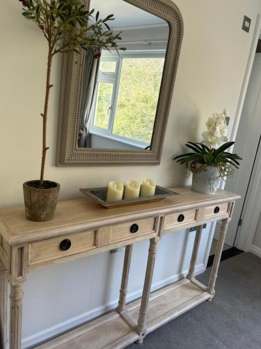 a wooden dressing table with a mirror on top at Gorey retreat main house in Gorey