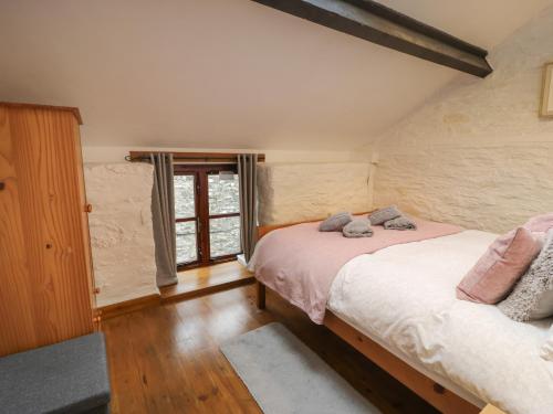 a bedroom with a bed and a window at Graig Las The Barn in Oswestry