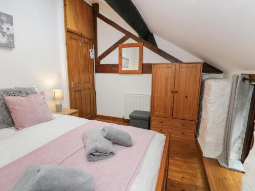 a bedroom with a bed with a towel on it at Graig Las The Barn in Oswestry