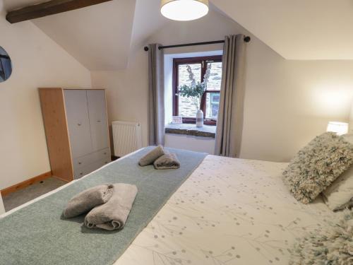a bedroom with a large bed with towels on it at Graig Las The Stables in Oswestry
