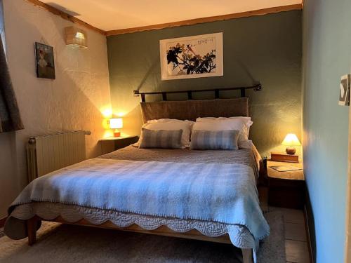 a bedroom with a large bed with a blue blanket at Appartement de Charme in La Plagne Tarentaise