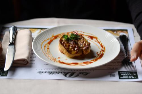 a plate with a piece of food on a table at La Chartreuse Du Val Saint Esprit in Gosnay