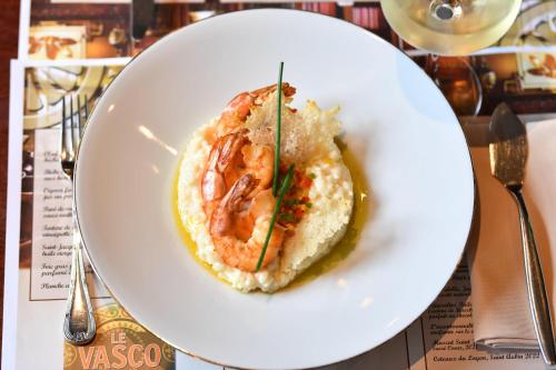 a plate of food with shrimp on top of rice at La Chartreuse Du Val Saint Esprit in Gosnay
