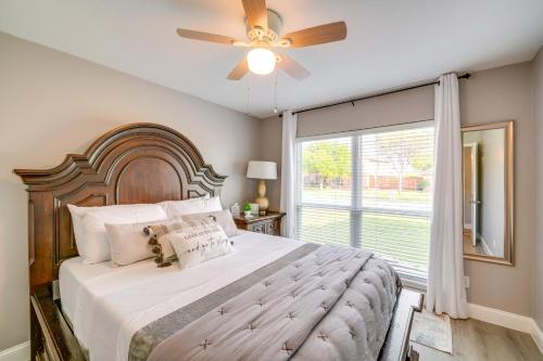 a bedroom with a large bed with a ceiling fan at Cozy Carrollton Cottage with Fire Pit and Gas Grill! in Carrollton