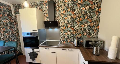 a kitchen with a counter with a microwave and a counter sidx sidx sidx at Traezh ar vag - Appartement Plage Perros-Guirec in Perros-Guirec