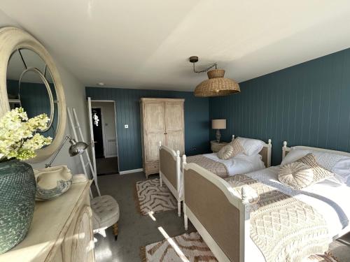 a bedroom with a bed and a mirror at Gorey retreat main house in Gorey