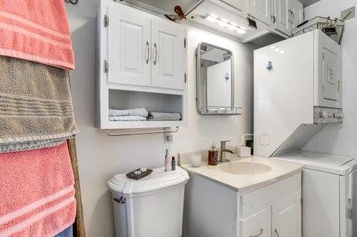 a bathroom with a sink and a toilet and a mirror at Dog-Friendly Westover Cottage with River Access! in Marion
