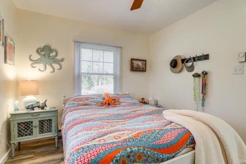 a bedroom with a bed and a window and an octopus decoration at Dog-Friendly Westover Cottage with River Access! in Marion