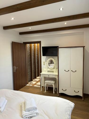 a bedroom with a bed and a dressing table at ERIETTA-AGAPI #1 in Kalabaka