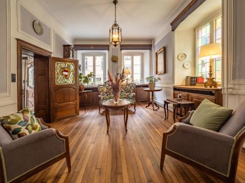 a living room with two chairs and a table at Hotel Heintz in Vianden