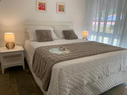 Кровать или кровати в номере Guest House Guarujá Hotel Boutique