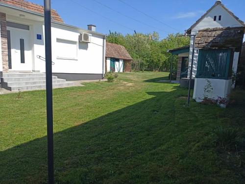 a yard with a house and a pole at Kuća za odmor BIĐ 