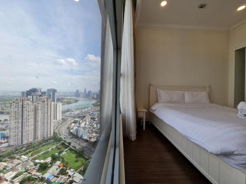 a bedroom with a window with a view of a city at Vinhome Landmark 81 Suites in Ho Chi Minh City