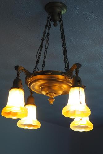 a chandelier hanging from a ceiling with four lights at Firefly Hills in Beattyville